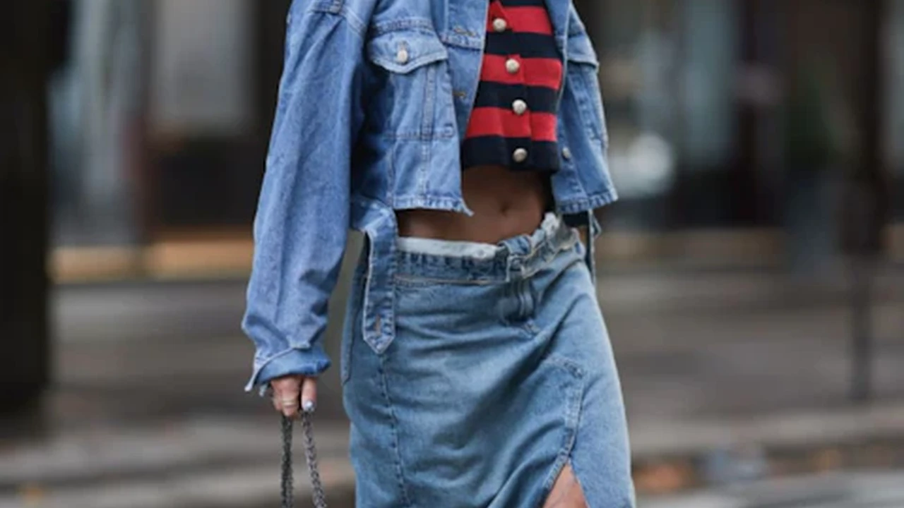 Close up on a plate of mashed potatoes, topped with baked pork chops with cream of mushroom soup, and a side of green beans.