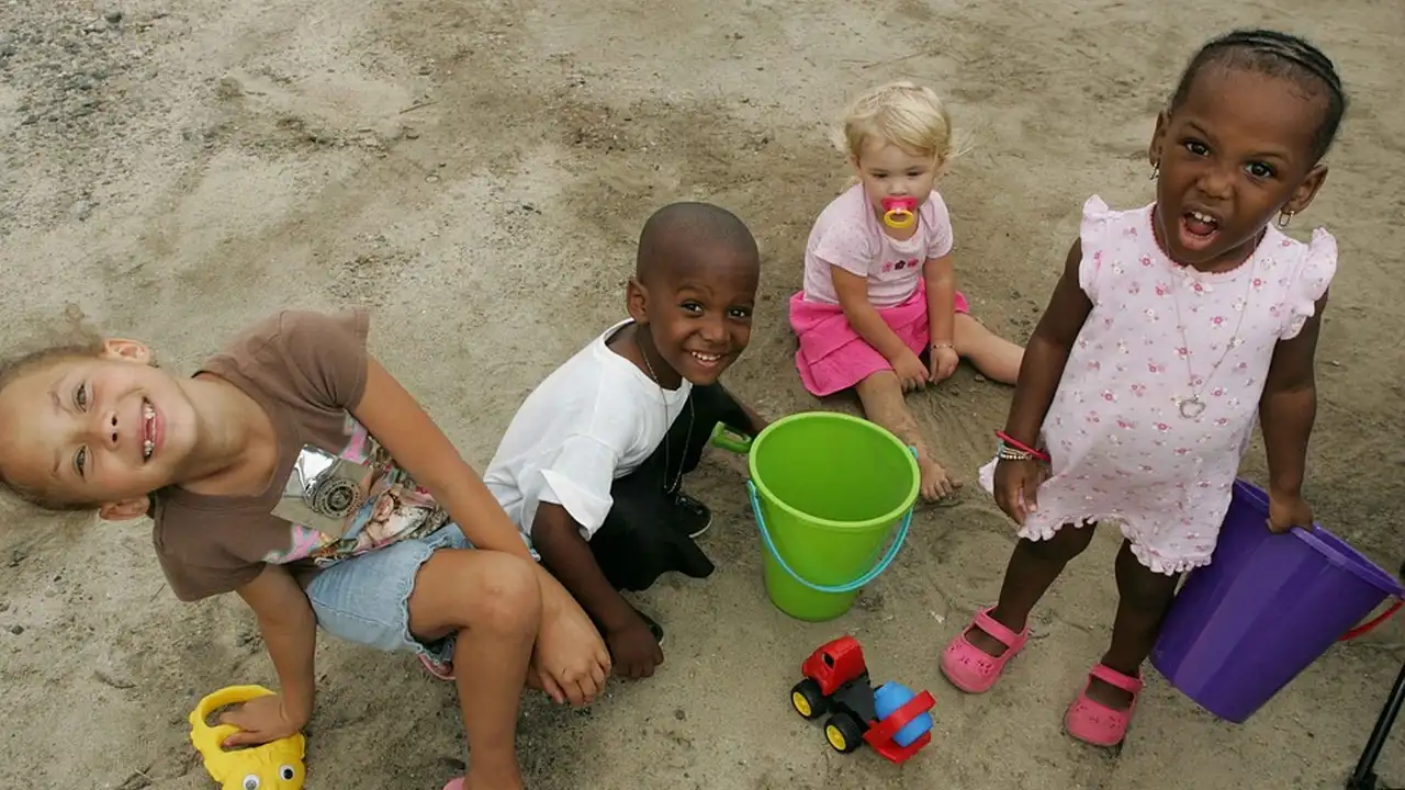 blue bowl of black bean beef tortilla soup on a board with cilantro and shredded cheese in background