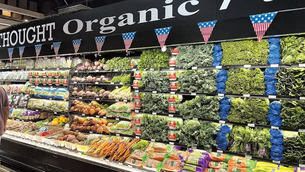 blue bowl of black bean beef tortilla soup on a board with cilantro and shredded cheese in background